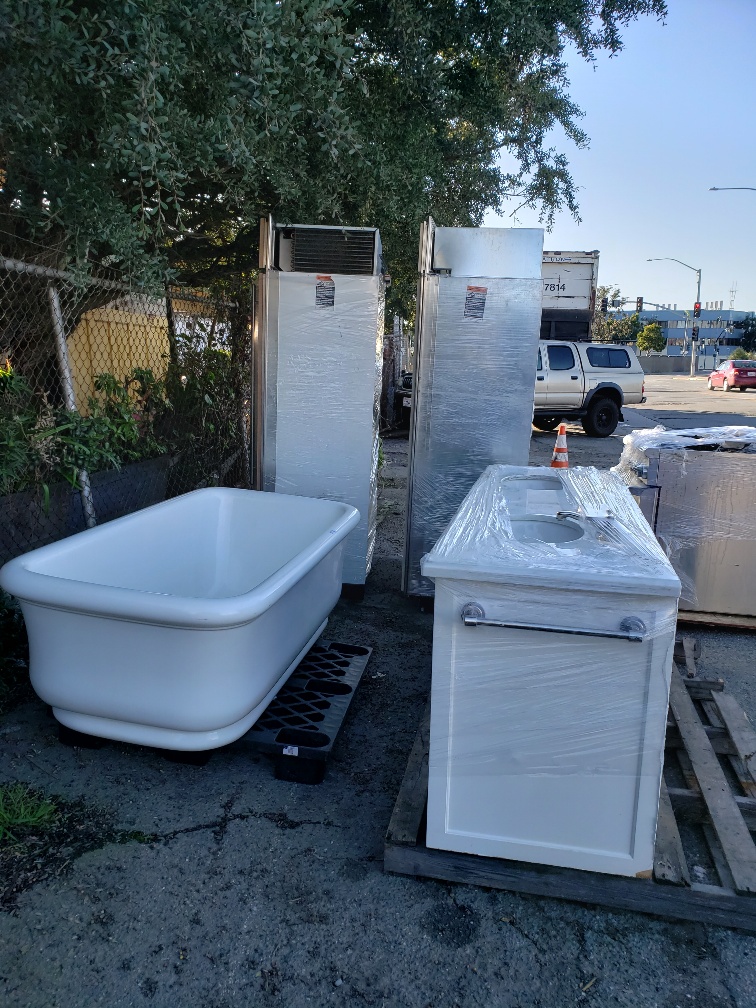 Salvaged tubs, fixtures, and appliances staged for donation